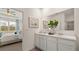Double vanity bathroom with white cabinets and a large mirror at 569 Whitman (Lot 159) Ln, Stockbridge, GA 30281