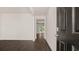 Bright entryway with dark front door and view into the living area at 576 Whitman (2020) Ln, Stockbridge, GA 30281