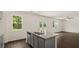 Modern kitchen island with granite countertop and gray cabinets at 576 Whitman (2020) Ln, Stockbridge, GA 30281