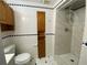 Basement bathroom with shower, toilet and wood cabinet at 1965 Tyler Trce, Lawrenceville, GA 30043