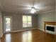 Gathering room featuring hardwood floors, fireplace, and access to deck at 1965 Tyler Trce, Lawrenceville, GA 30043