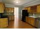 Kitchen with wood cabinets, granite countertops, and stainless steel appliances at 1965 Tyler Trce, Lawrenceville, GA 30043