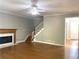 Living room with hardwood floors, fireplace, and staircase at 1965 Tyler Trce, Lawrenceville, GA 30043