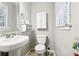 Small bathroom with toilet, sink, and a small cabinet at 386 Black Oak Ct, Lawrenceville, GA 30046