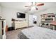 Comfortable bedroom with a dresser, TV, and ceiling fan at 386 Black Oak Ct, Lawrenceville, GA 30046