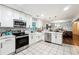 Modern kitchen featuring white cabinets, stainless steel appliances, and an island at 386 Black Oak Ct, Lawrenceville, GA 30046