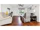 Living room featuring hardwood floors, comfy armchairs, and large mirror at 386 Black Oak Ct, Lawrenceville, GA 30046
