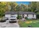 Ranch style home with a well-maintained lawn and driveway at 386 Black Oak Ct, Lawrenceville, GA 30046
