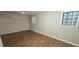 Simple bedroom with neutral walls and wood-look flooring at 3226 Bruckner Blvd, Snellville, GA 30078