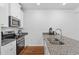 Kitchen boasts granite countertops and stainless steel appliances at 1916 School House Ln, Temple, GA 30179