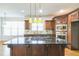 Island kitchen with granite countertops and dark wood cabinets at 3939 Perry Pass, Lithonia, GA 30038