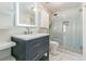 Modern bathroom with a navy vanity, frameless shower, and marble tile at 3939 Perry Pass, Lithonia, GA 30038