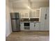 Basement kitchenette with white cabinets and granite countertop at 3939 Perry Pass, Lithonia, GA 30038