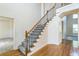 Elegant staircase with wood railing and gray carpeting at 3939 Perry Pass, Lithonia, GA 30038