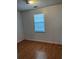 Simple bedroom with wood flooring and window at 209 E Wilson St # 2, Villa Rica, GA 30180