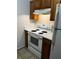 Kitchen features white appliances and wood cabinets at 209 E Wilson St # 2, Villa Rica, GA 30180
