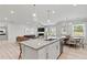 Open kitchen with island, stainless steel appliances, and breakfast area at 402 Beacon Way, Villa Rica, GA 30180