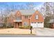 Brick house with a two-car garage and manicured lawn at 2865 Payton Oaks Ne Dr, Atlanta, GA 30345