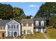 Three-unit townhouse building with gray and yellow siding at 3971 Wolcott Cir # 3971, Atlanta, GA 30340
