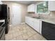 Modern kitchen featuring white cabinets, stainless steel appliances, and tile flooring at 125 Cainwood W Ct, Atlanta, GA 30349