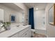 Bathroom with white vanity, tub, and blue shower curtain at 1261 Arnhem Dr, Hampton, GA 30228
