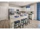 Modern kitchen with white cabinets, granite island, and stainless steel appliances at 1261 Arnhem Dr, Hampton, GA 30228