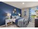 Bedroom with blue accent wall, metal bed frame, and window at 1261 Arnhem Dr, Hampton, GA 30228
