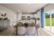 Open concept dining area with kitchen and backyard views at 1261 Arnhem Dr, Hampton, GA 30228