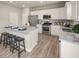 Modern kitchen with white cabinets, granite counters and island at 1261 Arnhem Dr, Hampton, GA 30228