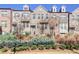 Three-story brick townhouse with gray door and landscaping at 1813 Hislop Ln, Atlanta, GA 30345