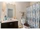 Clean bathroom with dark vanity and shower/tub combo at 6918 Diamond Dr, Rex, GA 30273
