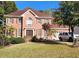 Brick house with a two-car garage and lush lawn at 1225 Creek Laurel Dr, Lawrenceville, GA 30043