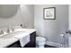 Modern powder room with dark vanity and white toilet at 244 Rope Mill Rd, Woodstock, GA 30188