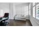 Home office with dark hardwood floors and a light-grey sofa at 244 Rope Mill Rd, Woodstock, GA 30188