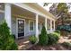 Home features a welcoming front porch with columns at 244 Rope Mill Rd, Woodstock, GA 30188
