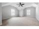 Bright bedroom featuring a ceiling fan and two windows at 244 Rope Mill Rd, Woodstock, GA 30188