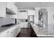 Modern kitchen featuring white cabinets, granite countertops, and stainless steel appliances at 244 Rope Mill Rd, Woodstock, GA 30188