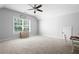 Spacious bonus room with large window and ceiling fan at 244 Rope Mill Rd, Woodstock, GA 30188