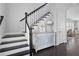 Elegant staircase with dark wood steps and white railings at 244 Rope Mill Rd, Woodstock, GA 30188