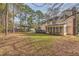 Spacious backyard with mature trees and a home with a deck at 2582 Fairview Ln, Jonesboro, GA 30236