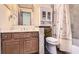 Bathroom with wood cabinets, shower/tub combo, and decorative accents at 2582 Fairview Ln, Jonesboro, GA 30236
