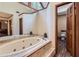 Bathroom with a large oval jetted tub and a separate toilet area at 2582 Fairview Ln, Jonesboro, GA 30236