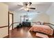 Spacious bedroom with hardwood floors, a ceiling fan, and a built-in workspace at 2582 Fairview Ln, Jonesboro, GA 30236
