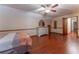 Hardwood floor bedroom with a dresser, ceiling fan, and access to hallway at 2582 Fairview Ln, Jonesboro, GA 30236