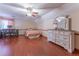 Bright bedroom featuring hardwood floors, a ceiling fan, and ample space at 2582 Fairview Ln, Jonesboro, GA 30236