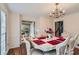 Elegant dining room featuring a formal table, chandelier, and hardwood floors at 2582 Fairview Ln, Jonesboro, GA 30236
