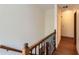 Upper level hallway with wood flooring and wrought iron railing at 2582 Fairview Ln, Jonesboro, GA 30236