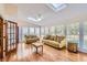 Bright sunroom features hardwood floors, skylights, and comfortable seating at 2582 Fairview Ln, Jonesboro, GA 30236