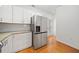 Modern kitchen with stainless steel refrigerator, white cabinets, and granite countertops at 520 Mary Sw St, Atlanta, GA 30310