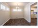 Dining area with dark wood floors and view into kitchen at 2775 Tilson Rd, Decatur, GA 30032